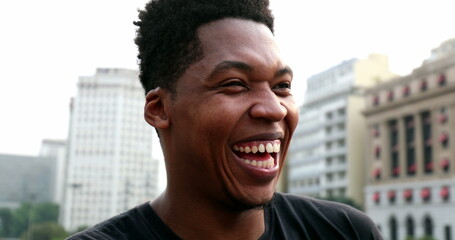 African black man smiling and laughing outside, real authentic people smile and laugh