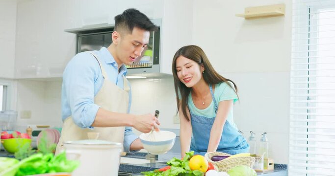 couple are cooking together