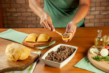 Woman preparing brazilian snacks beef stufing croquette (risolis de carne)