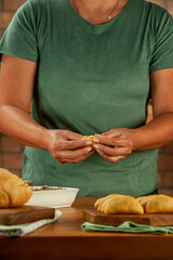 Woman preparing brazilian snacks beef stufing croquette (risolis de carne)