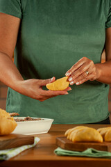 Obraz na płótnie Canvas Woman hands holding brazilian snacks beef stufing croquette (risolis de carne)