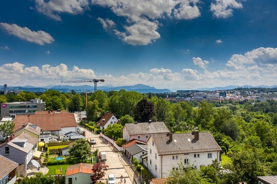 Aerial drone view of Kempten town surrounded by beautiful  Alpine mountains against a blue sky