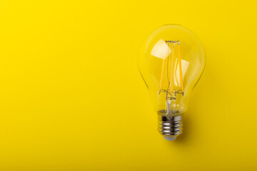 Electric light bulbs. the concept of energy efficiency. Composition on a yellow background. Use an...