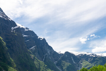 Fototapeta na wymiar Green nature among high mountains in Norway