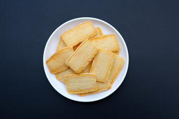Cheese crispies on dark background.