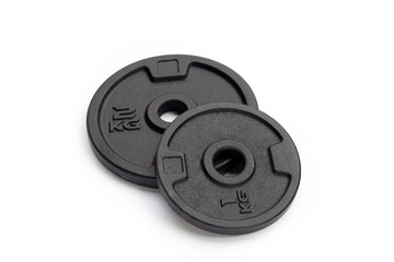 Black weight plates on white background. Gym equipment