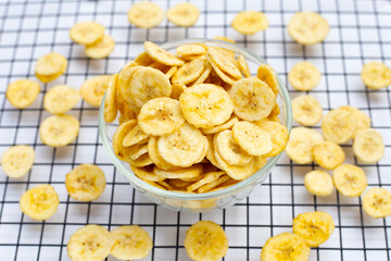 Banana slice chips on white background.