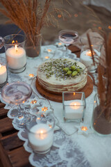 picnic in the evening at sunset on the sandy shore of the sea or ocean. decor in boho and rustic...