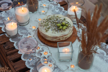 picnic in the evening at sunset on the sandy shore of the sea or ocean. decor in boho and rustic...