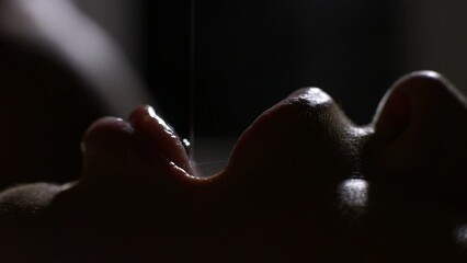 Man seduces woman in bed dripping honey in her mouth