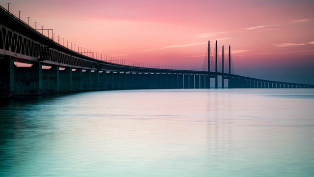 Pink sunset view from the Malmo coast -The Oresund Bridge crossing over the Oresund strait