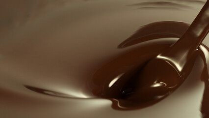 Close-up of stirring stream of melted chocolate.