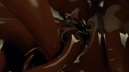Close-up of pouring stream of melted chocolate.