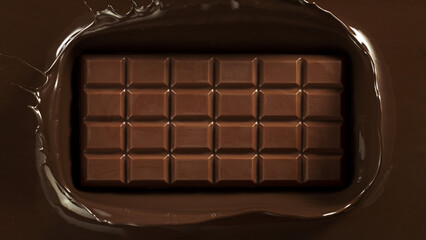 Chocolate bar with chocolate splashing around.