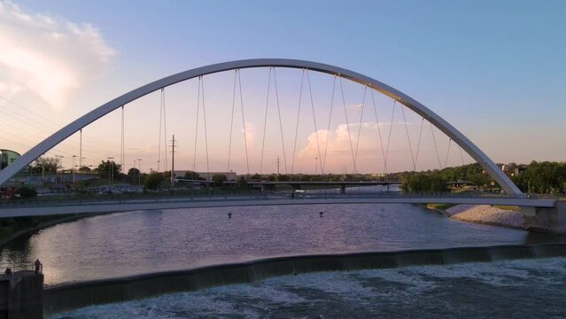 Colorful aerial drone view pushing toward Center Street Bridge in Des Moines, Iowa at sunset