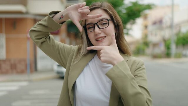 Young woman business worker doing photo gesture at street