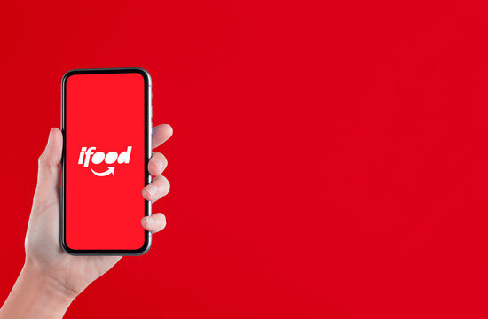 Sao Paulo, Brazil; JULY 22, 2022: Woman holding a mobile phone with &ldquo;IFOOD&rdquo; app