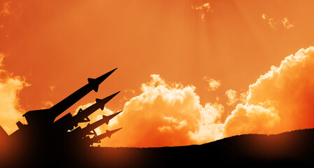 The missiles are aimed at the sky at sunset. Nuclear bomb, chemical weapons, missile defense.