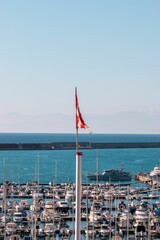 Flag on a mast in a port in Genoa, Italy