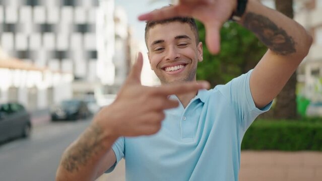African american man smiling confident doing photo gesture with hands at park