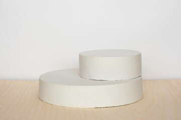 Podium for presentation on wooden table, white backround. Abstract geometrical form. Cylinder stone...