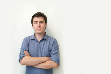 young attractive man in a blue shirt on a white background copy space. portrait of a positive young man