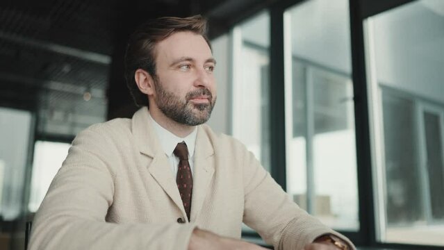 Confident brunet businessman listening his colleague in the office 