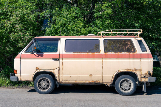an old vintage rusty minibus standing in the yard. hippie culture