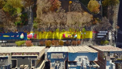 Aerial birds eye overhead top down view of inflating large balloons for thanksgiving parade on street along park. Manhattan, New York City, USA - Powered by Adobe