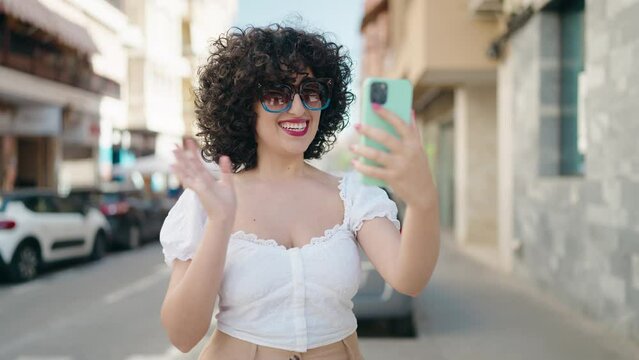 Young middle east woman smiling confident having video call at street