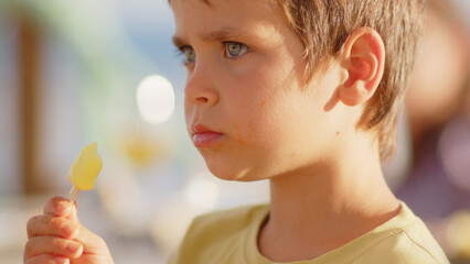 4 sibling boys look at the camera smiling, play while running through a restaurant in front of the camera, eat ice cream, hug their mother