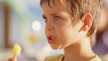 4 sibling boys look at the camera smiling, play while running through a restaurant in front of the camera, eat ice cream, hug their mother