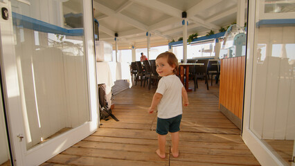 Wonderful family - father, mother and 4 sons (1-8 years old) - walk along one of the most beautiful beaches of Cádiz at sunset - they love and hug each other, look after their children