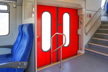 Closed red doors modern european economy class fast train. Doors inside of high speed train...