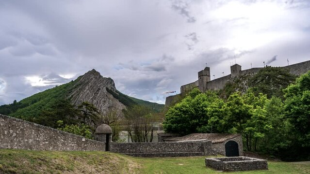 Time lapse footage of the Citadelle de Sisteron in France inder a gloomy sky