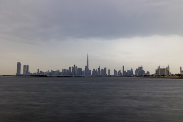 Fototapeta na wymiar Dubai on a rainy or cloudy day. Dramatic shot of Dubai Skyline or Skyscrapers or Buildings