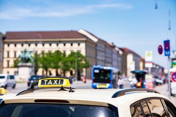 Close-up shot of a taxi sign on the car in the streets of Munich, Germany