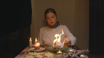 4K. Slavic woman set fire to paper