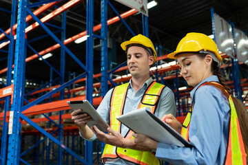 Caucasian two engineer team shipping order detail on tablet check goods and supplies on shelves with goods background inventory in factory warehouse.logistic industry and business export