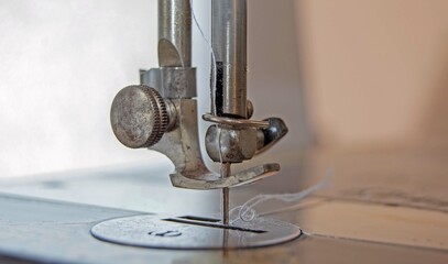 Close-up of the needle of an old sewing machine.