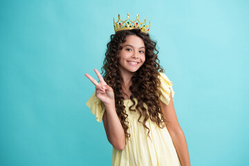 Teen child in queen crown isolated on blue background. Princess girl in tiara. Teenage girl wear...