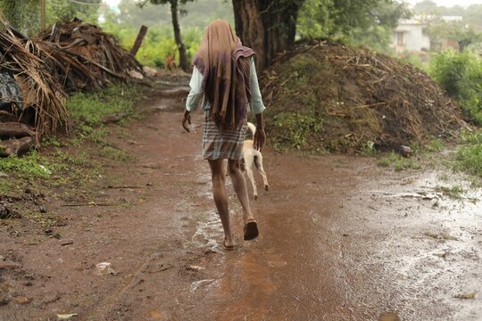 Person wearing old clothes and walking in a forest in Bidar, India
