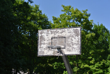 Old basketball hoop on a sunny summer day.