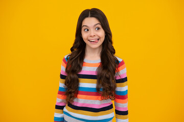 Fototapeta premium Funny kids face. Portrait of silly teenager child girl smiling and showing tongue in camera making funny faces.