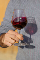 man holding a glass of  red wine