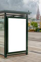 Vertical shot of a blank billboard on a bus stop in the city center with copy space