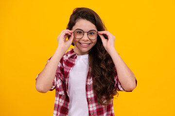 Ophthalmologist tries on eyeglasses of teenager little girl, close-up. Treatment of childrens vision with glasses. Happy teenager, positive and smiling emotions of teen girl.