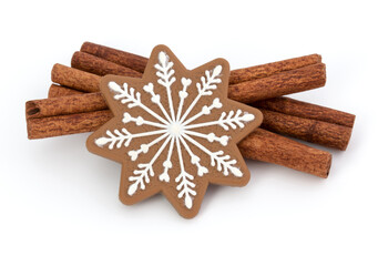 cinnamon sticks and ginger bread cookies isolated on white background close up, christmas concept
