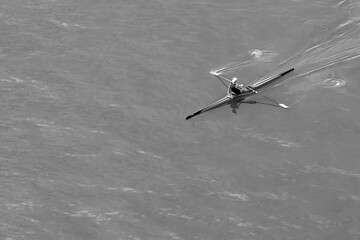 Aerial photo of a peaceful early morning rowing, single skull, workout along a calm river.
