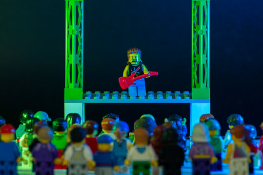 Lego rock star minifigure playing guitar and performing a solo concert on stage
